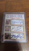 Front of the Iconic Ink Triple Cuts card featuring facsimile autographs of Michael Jordan, Kobe Bryant, and LeBron James with their photos and names.