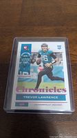 Front view of Trevor Lawrence rookie card showing him in Jaguars uniform, labelled Chronicles.