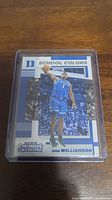 Front side of Zion Williamson rookie card displaying him in Duke basketball uniform with the 'School Colors' theme and Panini Contenders branding.