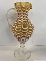Full view of Murano glass pitcher showing shape, pattern, handle, and pedestal base.