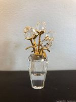 Front view of the small Swarovski crystal vase with gold-tone metal top and clear crystal roses.