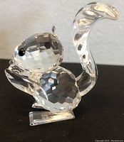 Side view of Swarovski crystal squirrel figurine showing faceted crystal body and curled tail.