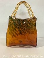 Front view of the Italian vintage glass handbag showing mottled amber coloring and clear twisted glass handle.