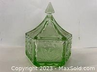 Green glass dish with lid and pointed finial.