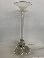 Full view of the vintage luster glass trumpet vase, showing its height, narrow neck, flared top, and triple spherical glass base.