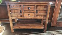 Front view of sideboard showing two slatted doors, two drawers, bottom shelf