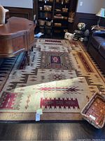 Full view of rug under furniture showing overall pattern and condition