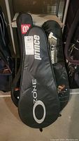 Three tennis racquet carrying cases including Prince and Wilson Hammer 6.2 models.