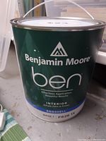Front view of a green Benjamin Moore paint can labeled 'ben' with interior acrylic paint and primer, eggshell finish, base F626 1X.
