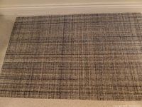 Full view of the Dash & Albert Harris Blue/Brown wool rug showing the overall color and pattern in shades of blue and brown on a soft creamy background.