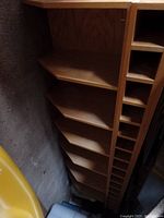 Photo of the corner shelves and wine rack section, shows angled shelves and multiple slots for wine bottles