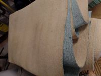 Photo of the beige rug pad with grey anti-slip backing, showing material and thickness