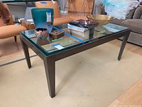 Three-quarter view of coffee table with decorative items on top (not included)