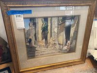 Full view of framed watercolor painting leaning against wall