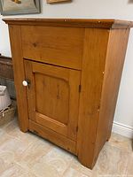 Angled front view of pine ice box showing overall structure and finish