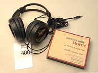 Black wired JVC over-ear headphones with cable and 3.5mm audio jack with the boxed 'Tuesdays With Morrie' audiobook CD set