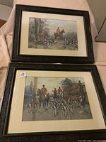 Pair of framed hunting prints laid flat, showing full artworks and frames.