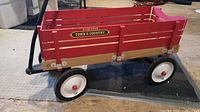 Red wooden Radio Flyer Town & Country wagon with removable wood bed and white wheels.