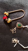 Full view of bracelet with all beads and three pendants on black fabric