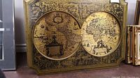Wide view of the metal print wall art showing double hemisphere world map with detailed edges and frame.