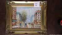 Full view of framed painting on floor with visible lot sticker.