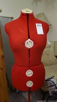 Front view of red sewing form on stand