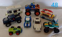 Eight LEGO vehicles viewed from above showing overall lot contents and color variations