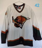 Full front view of the white Utah Grizzlies hockey jersey with visible team logo and sleeve striping.