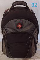 Front view showing multiple zippered compartments and Wenger logo