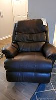 Front view of dark mahogany leather La-Z-Boy electric recliner chair, showing padded seat, armrests, and plush backrest.
