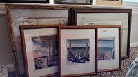 Five framed pieces of wall art including watercolors and photographs. Four wooden frames, two have beach-themed photos with beach chairs and ocean views.