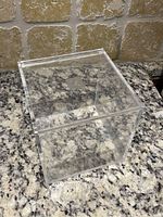 Clear acrylic cube storage unit closed, showing shape and size.