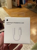 Front of retail box showing product image and name 'Lightning to Headphone Jack Adapter'.