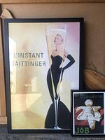 Full view of both framed prints showing Taittinger Champagne and Papier Cigarettes ads
