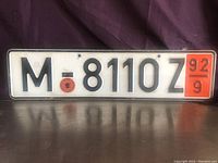 Front view of the German vintage license plate showing characters, seal, and inspection sticker.