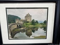 Front view of framed vintage photo of an Irish castle with stone bridge and water reflection.