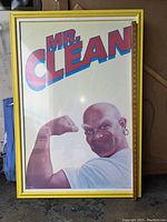Front view of the framed Mr. Clean poster showing the mascot flexing his arm and the bold MR. CLEAN text at the top.