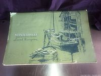 Photo of original green box with sketch of boats and text, packaging for Lionel Barrymore placemats