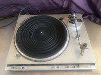 Top and angled views of Technics SL-BD3 turntable showing platter, tonearm, cartridge, control buttons, and missing dust cover.
