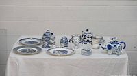 Front view of all blue and white ceramic items arranged on table