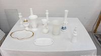 Full lot on table showing all items: vases, candle holders, figurine, dishes.
