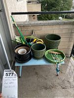 Full view of the blue table on balcony holding all pots, tools and decorations showing their relative size and condition.