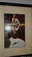 Photo of Native American riders art showing detailed scene and reflection on glass.
