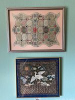 Front view of both framed textiles hung on wall