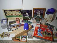 Wide view of all items including signed photos, card piles, mini helmets, bobblehead, and albums
