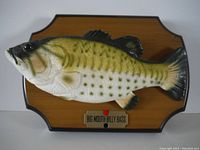Front view of the mounted Big Mouth Billy Bass animatronic fish and its plaque.