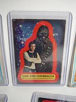 Close-up image of Han and Chewbacca sticker with red border in protective sleeve