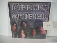 Front cover of Deep Purple's Machine Head album showing embossed text and blurred band member faces.