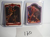 Front view of two KISS trading cards #43 and #47 featuring Gene Simmons in plastic sleeves