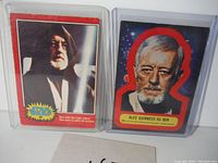 Obi-Wan Kenobi collectible card and Alec Guinness Ben Kenobi die-cut sticker in protective sleeves